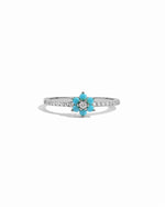 Ring with turquoise flower-shaped gem and white diamond accents on a white background