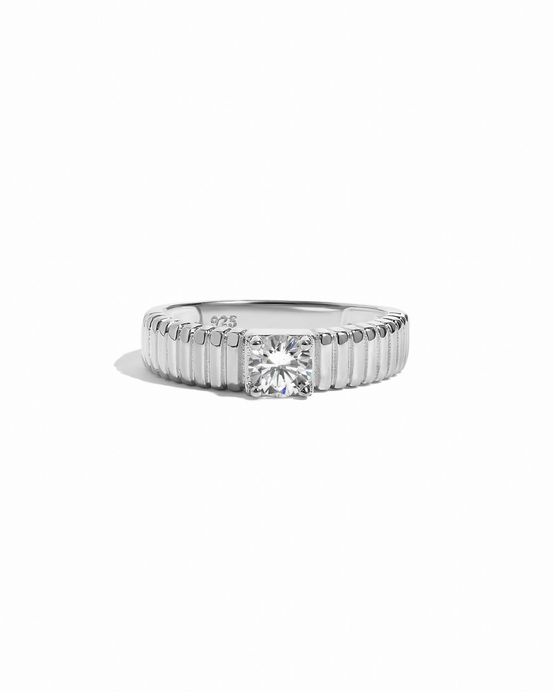 flat lay of a Unique Gold Ring that feels both sturdy and delicate, with its precisely grooved design, set in sterling silver. 