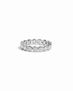 Silver eternity ring with heart-shaped gemstones on a white background