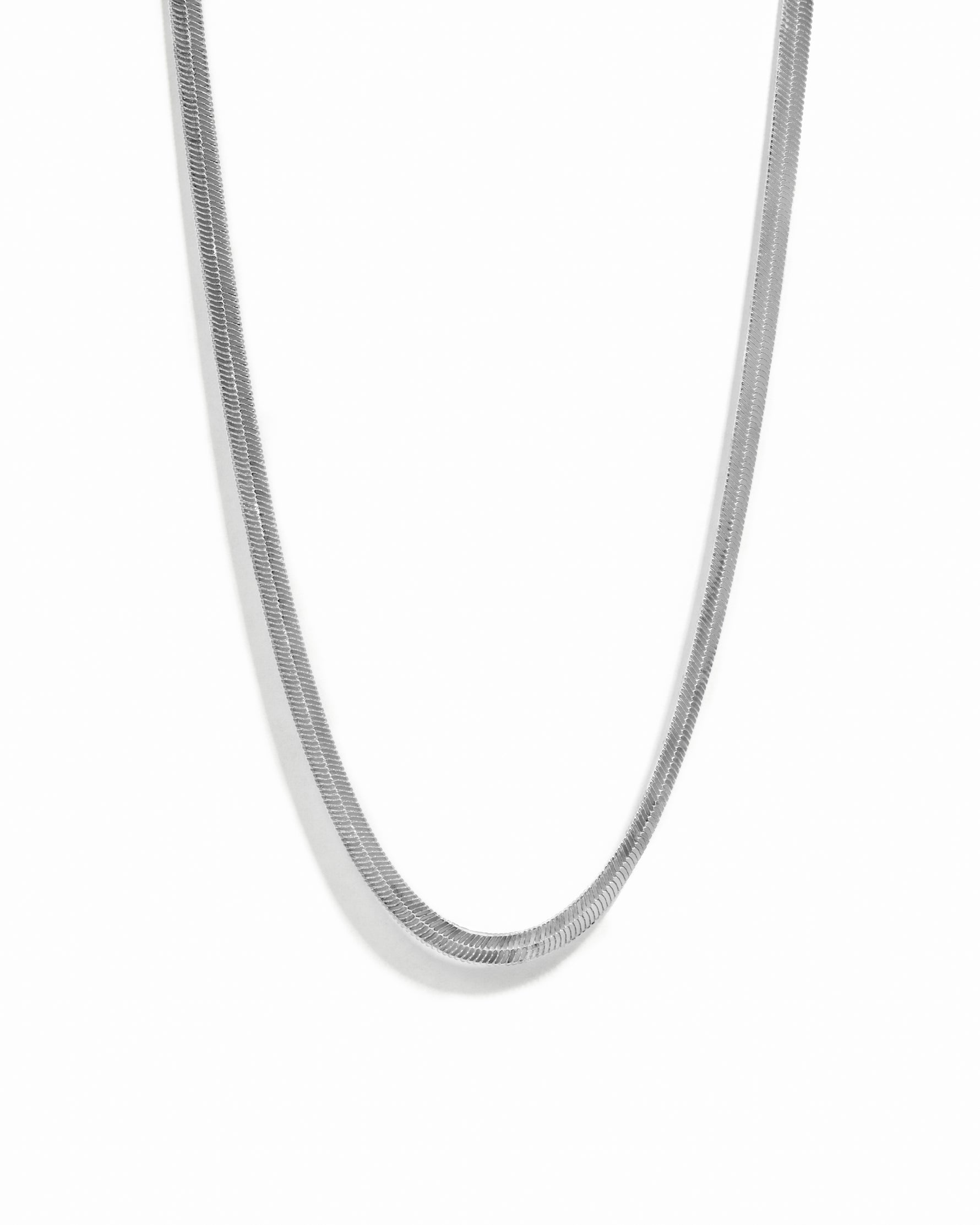 Silver herringbone necklace on a white background