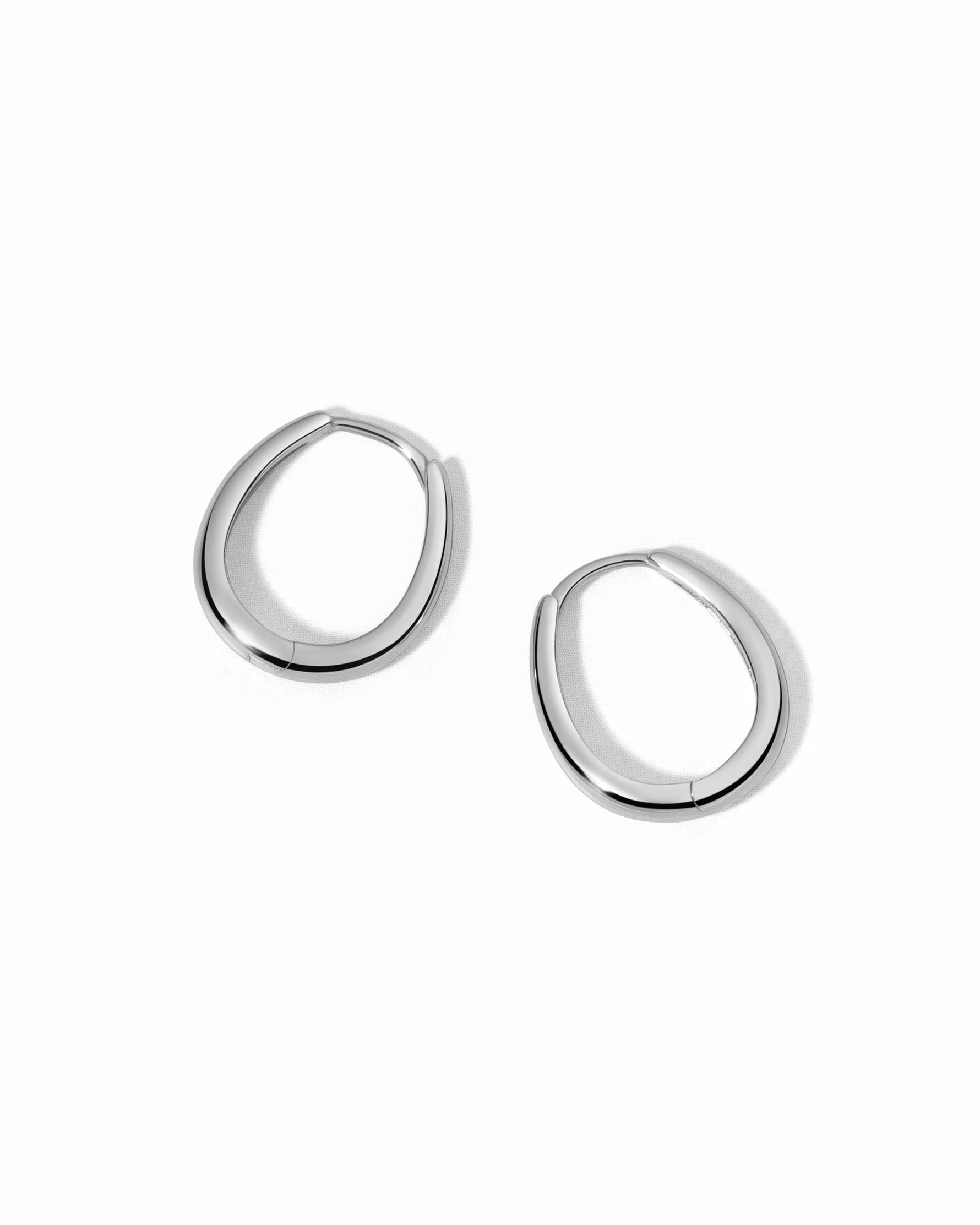 Pair of silver hoop earrings on a white background