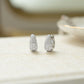 closeup image of small silver huggie hoops with cubic zirconia diamonds  