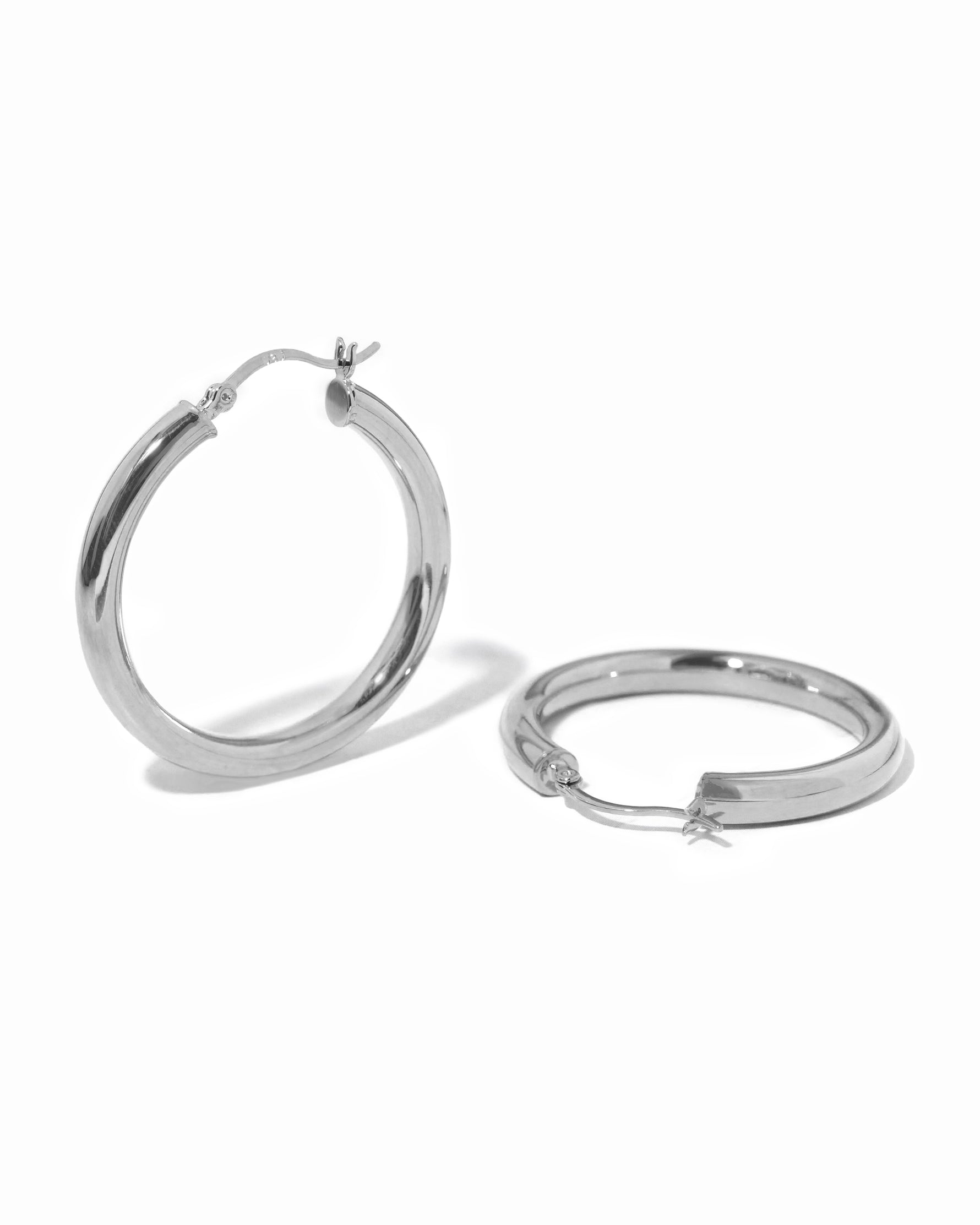 Silver madison beer lightweight hoop earrings on white background