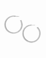 Pair of silver hoop earrings on a white background