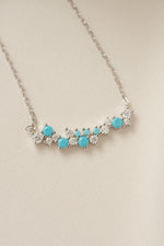 boho necklace with a beaded necklace design with turquoise stones on a beige background