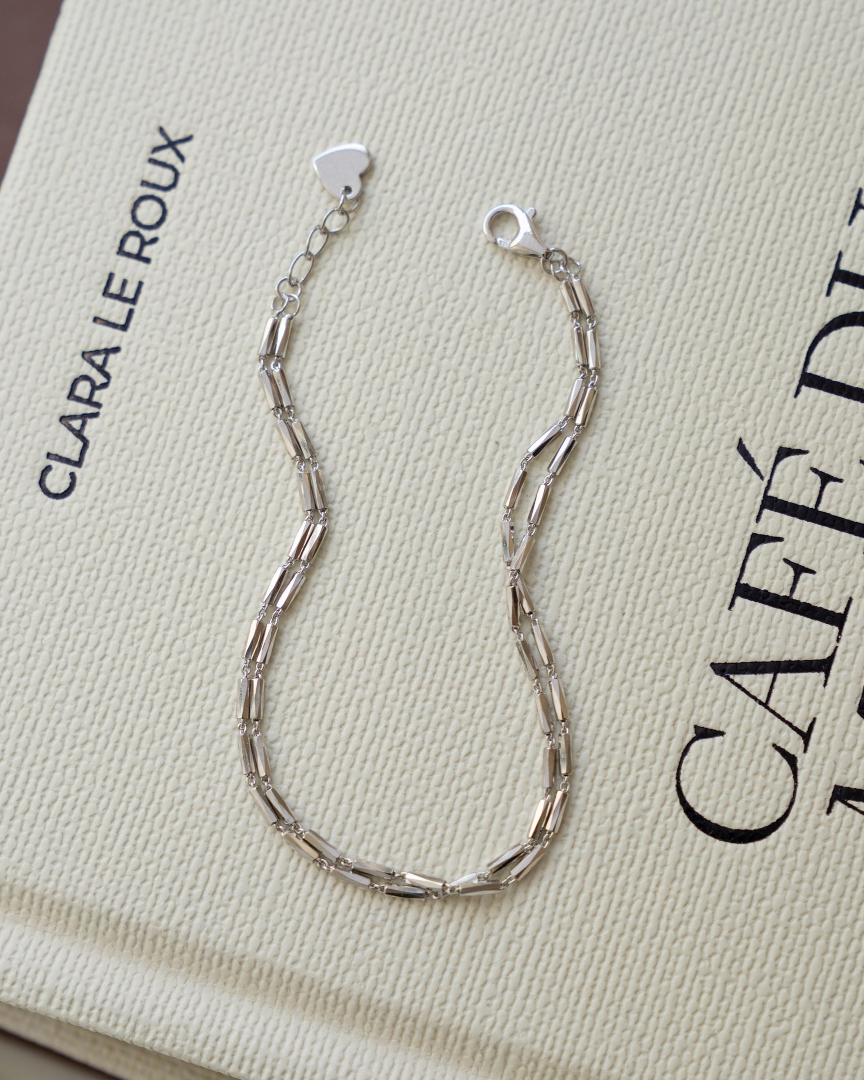 Sterling silver adjustable bracelet featuring a beaded bracelet design on a coffee table book