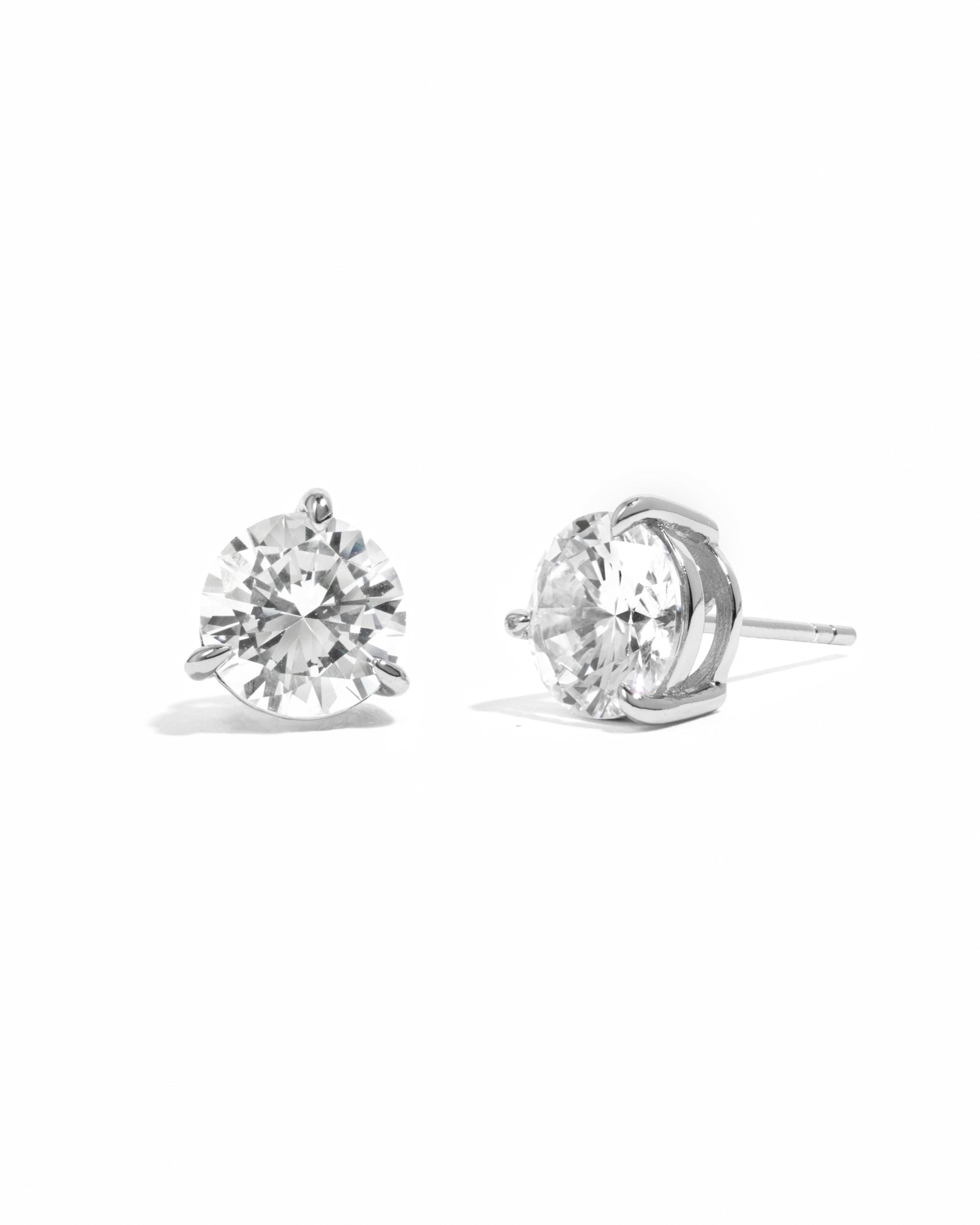Pair of diamond stud earrings on a white background