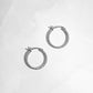 Closeup image of silver minimalist hoop earring