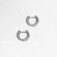 closeup image of delicate silver small hoop earrings