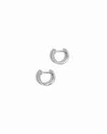 closeup image of delicate silver small hoop earrings