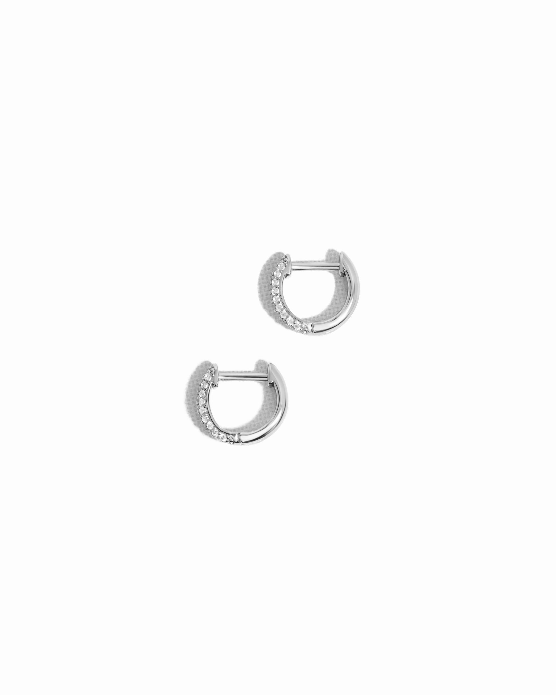 closeup image of delicate silver small hoop earrings