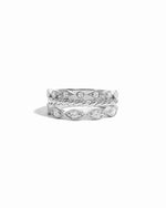 Three silver dainty rings on a white background
