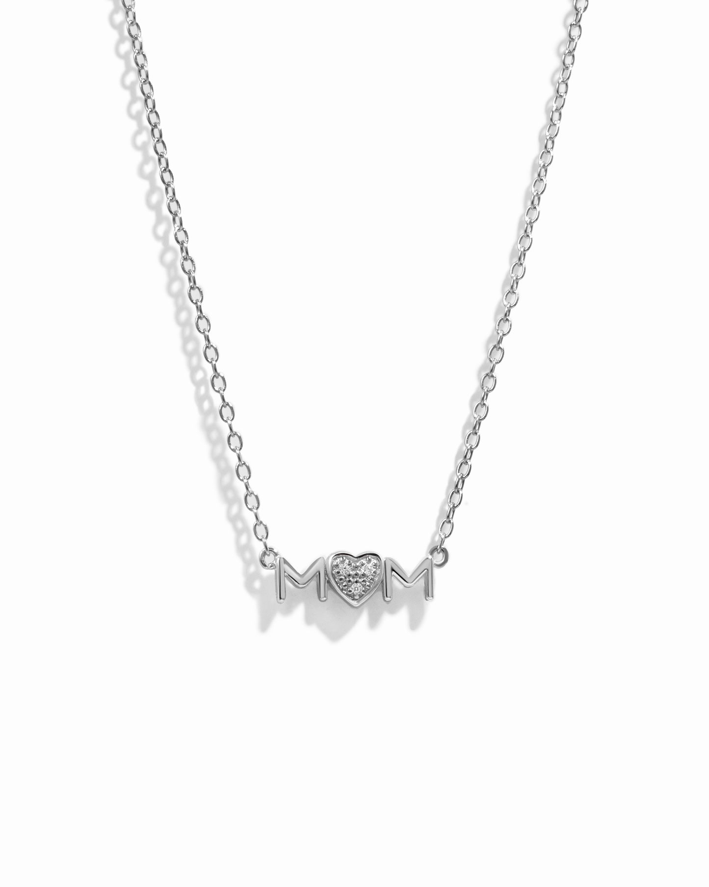 Closeup image of dainty Mom Heart Pendant on silver chain