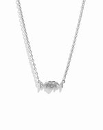 Closeup image of dainty Mom Heart Pendant on silver chain