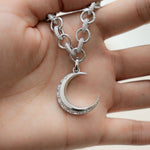 model holding silver pendant necklace with diamond moon pendant