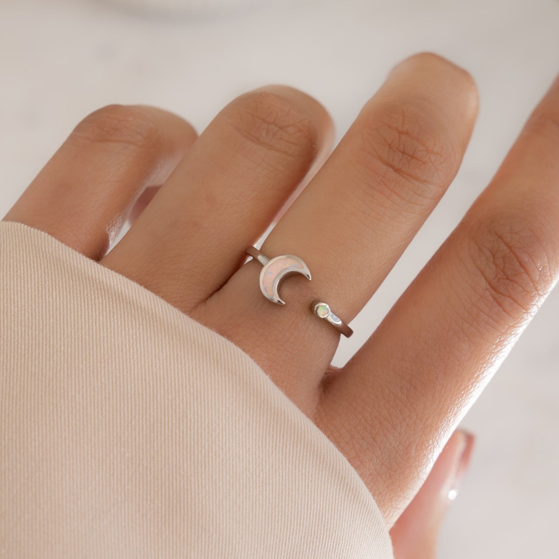 model wearing sterling silver adjustable opal ring