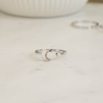 closeup image of sterling silver adjustable opal moon ring