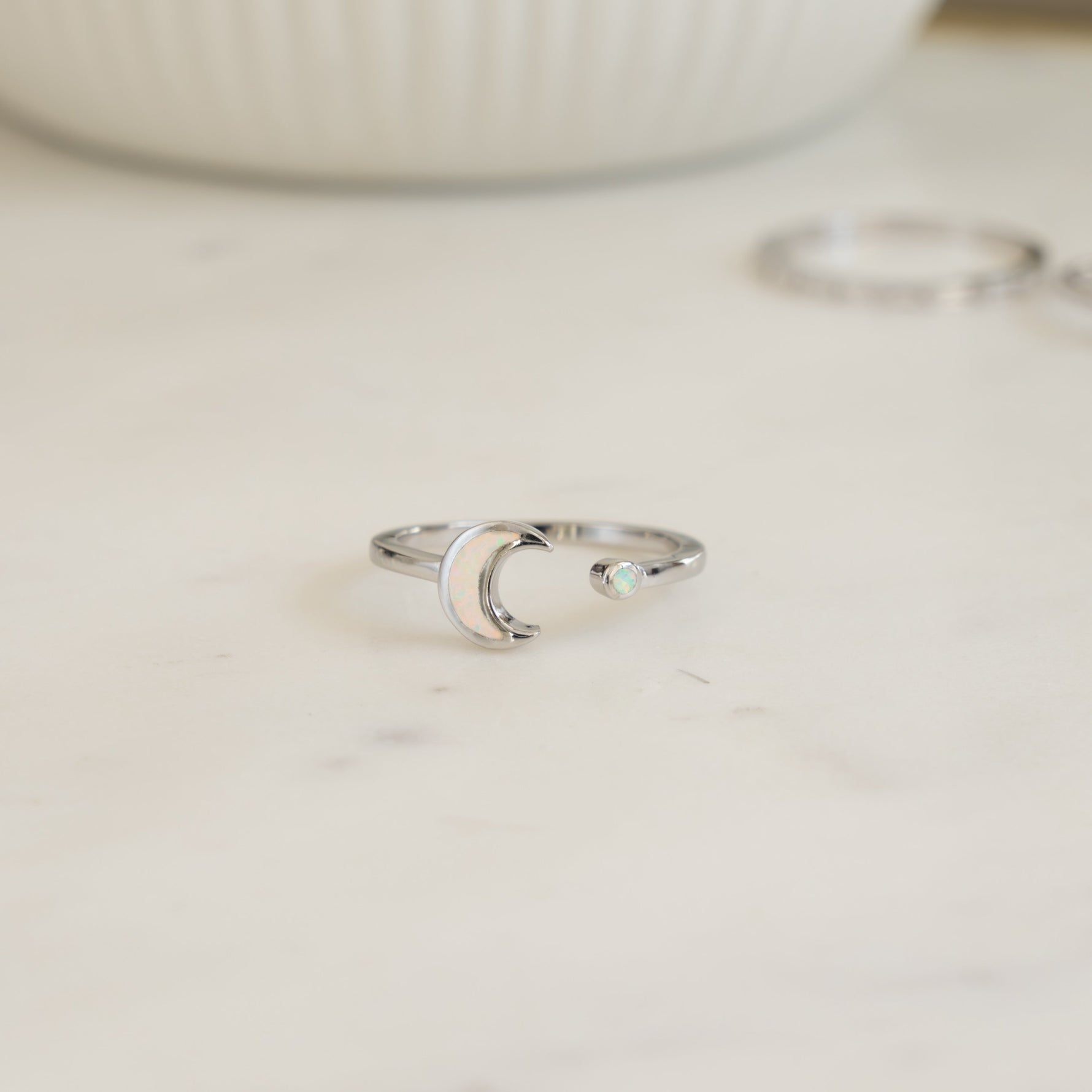 closeup image of sterling silver adjustable opal moon ring