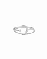 Silver ring with a crescent moon design on a white background
