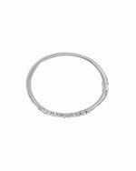 Overhead view of silver stacking bracelet with a bangle bracelet design