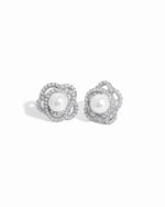 closeup image of sterling silver statement earrings with pearl earring design and floral earring design
