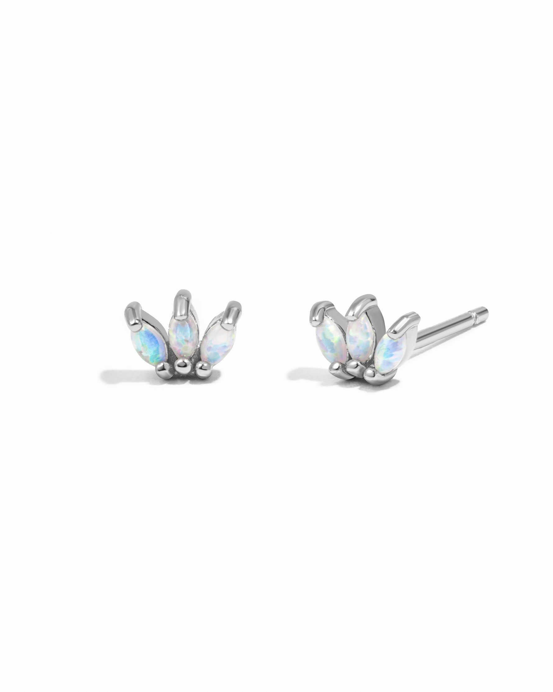 Pair of silver floral earrings with opal stones on a white background