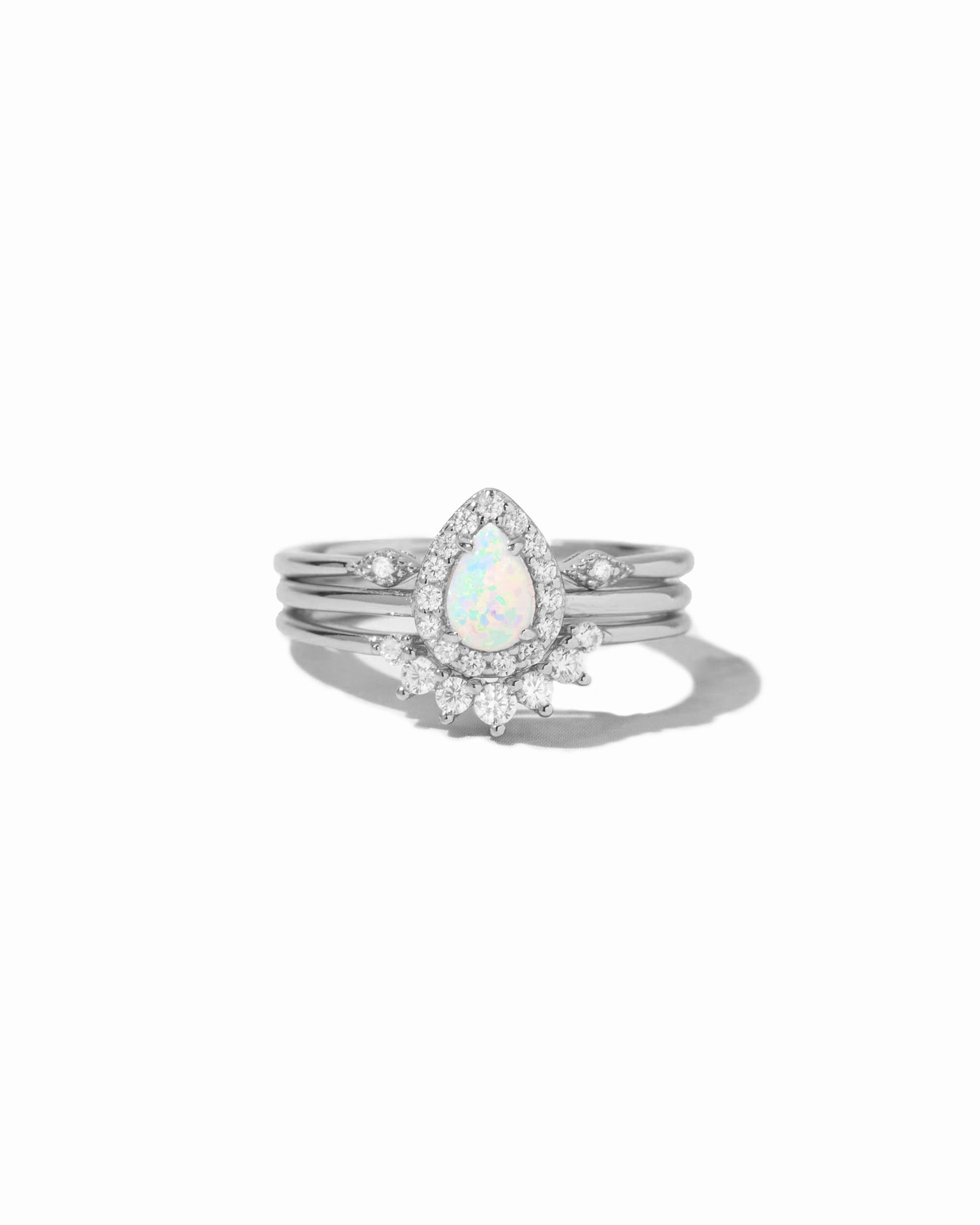 silver opal ring set with a central opal stone on a white background