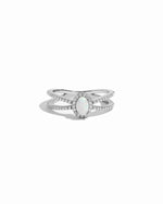 Silver ring with a central opal gemstone on a white background