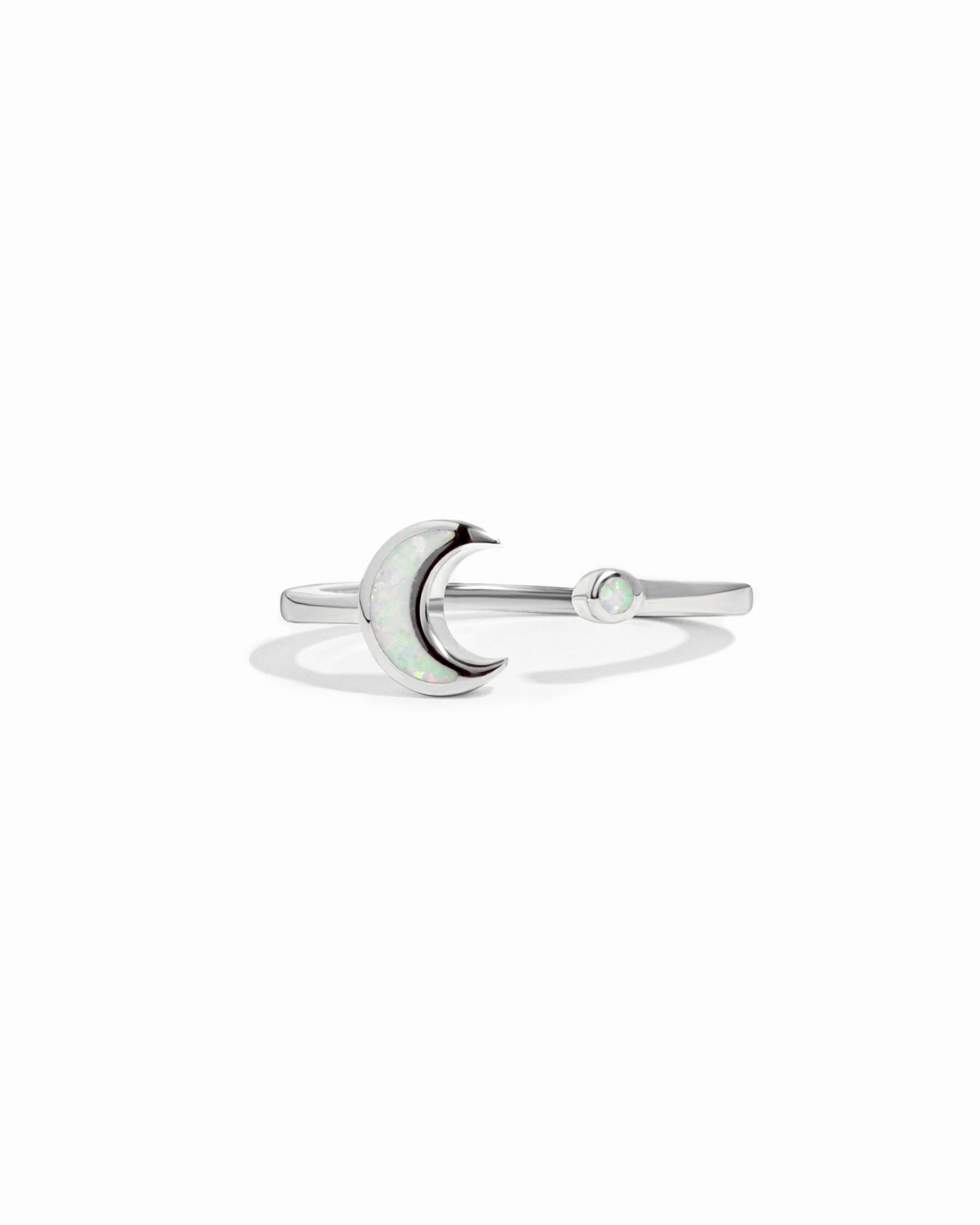 closeup image of silver opal ring with moon design