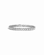 closeup image of silver oval diamond bezel set tennis bracelet