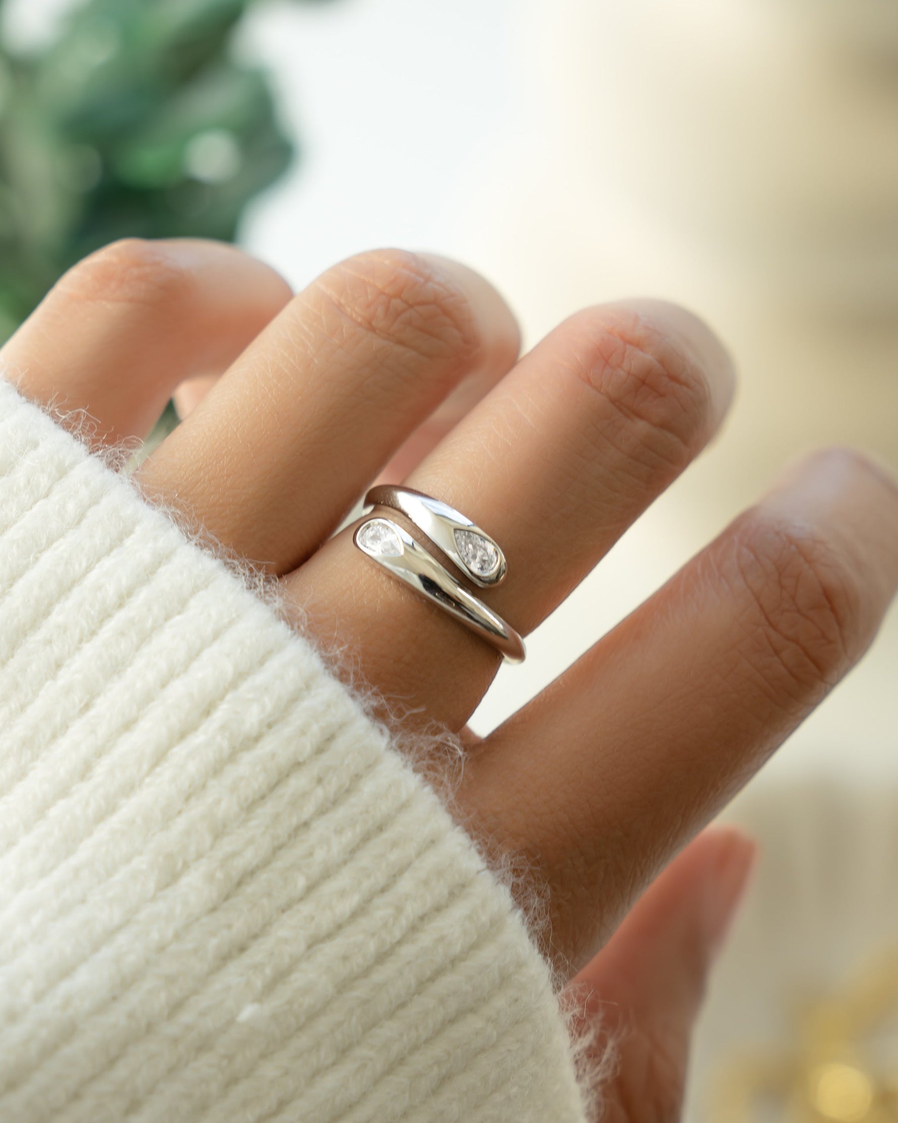 Sterling silver vintage jewelry featuring a silver pear ring on models hand