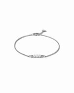 Silver bracelet with pearls on a white background