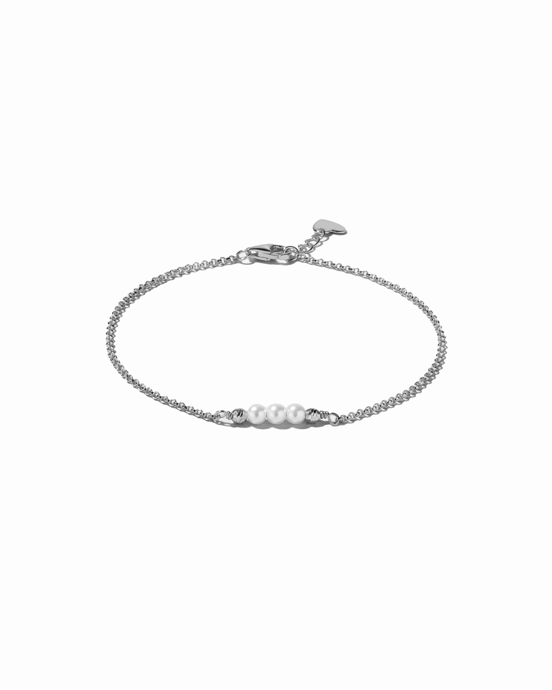 Silver bracelet with pearls on a white background