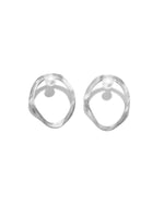 closeup image of silver summer earrings featuring a big pearl earring