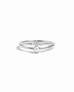 Silver ring set with a pearl and small diamonds on a white background