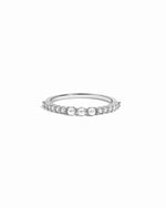 Sterling Silver ring with 3 pearls and tiny diamonds along the band on a white background