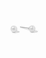 Pair of silver pearl stud earrings on a white background
