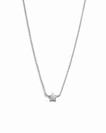 Silver star necklace on a white background