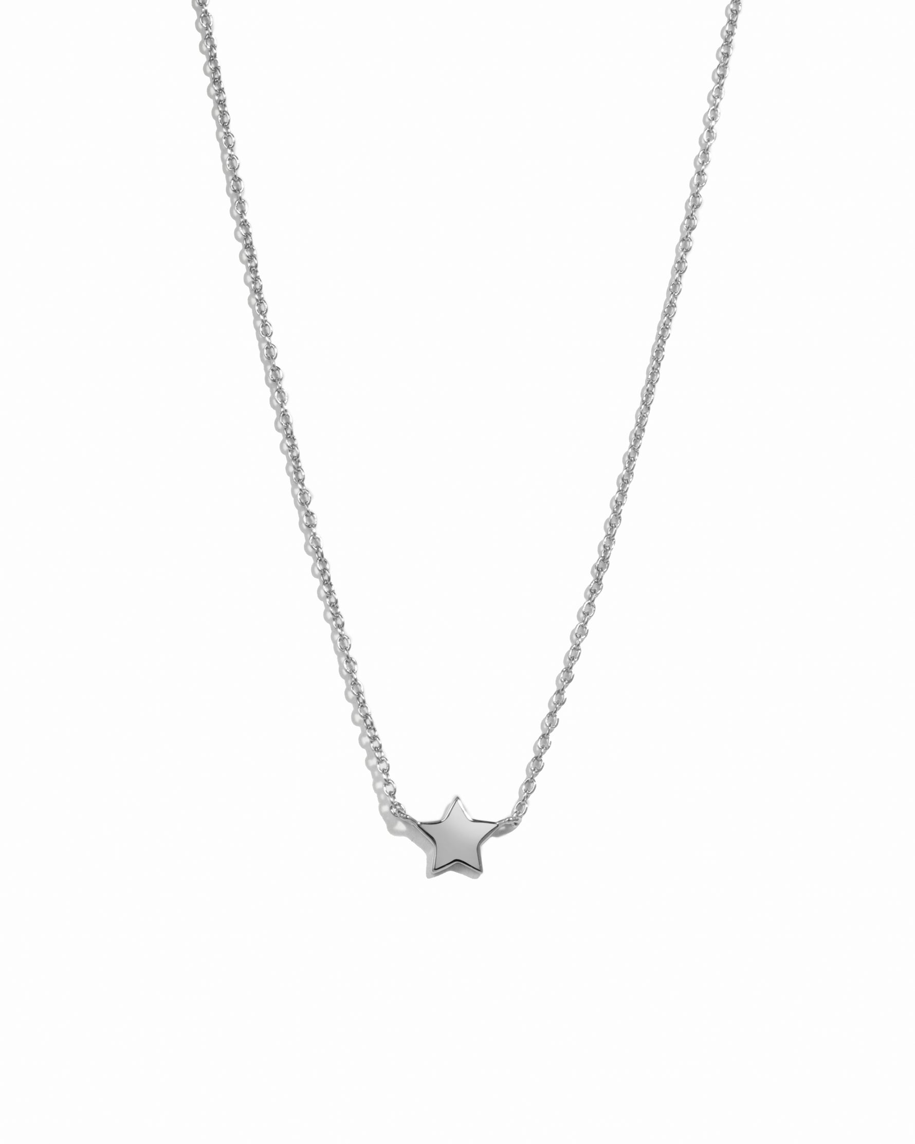Silver star necklace on a white background