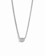 Silver necklace with a small diamond pendant on a white background