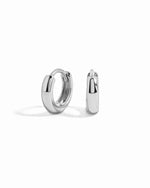 Pair of silver chunky hoop earrings on a white background