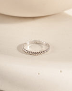 sterling Silver ring on a beige surface