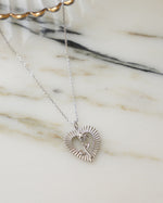 Silver chain rose necklace on a marble background