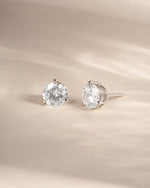 Sterling silver stud earrings on a neutral background