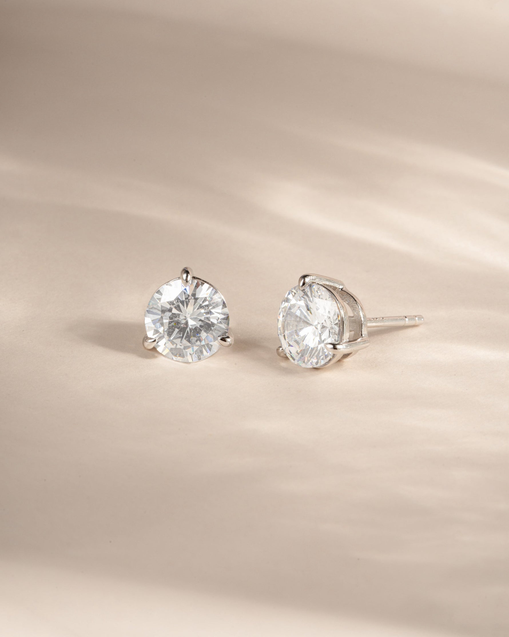 Sterling silver stud earrings on a neutral background