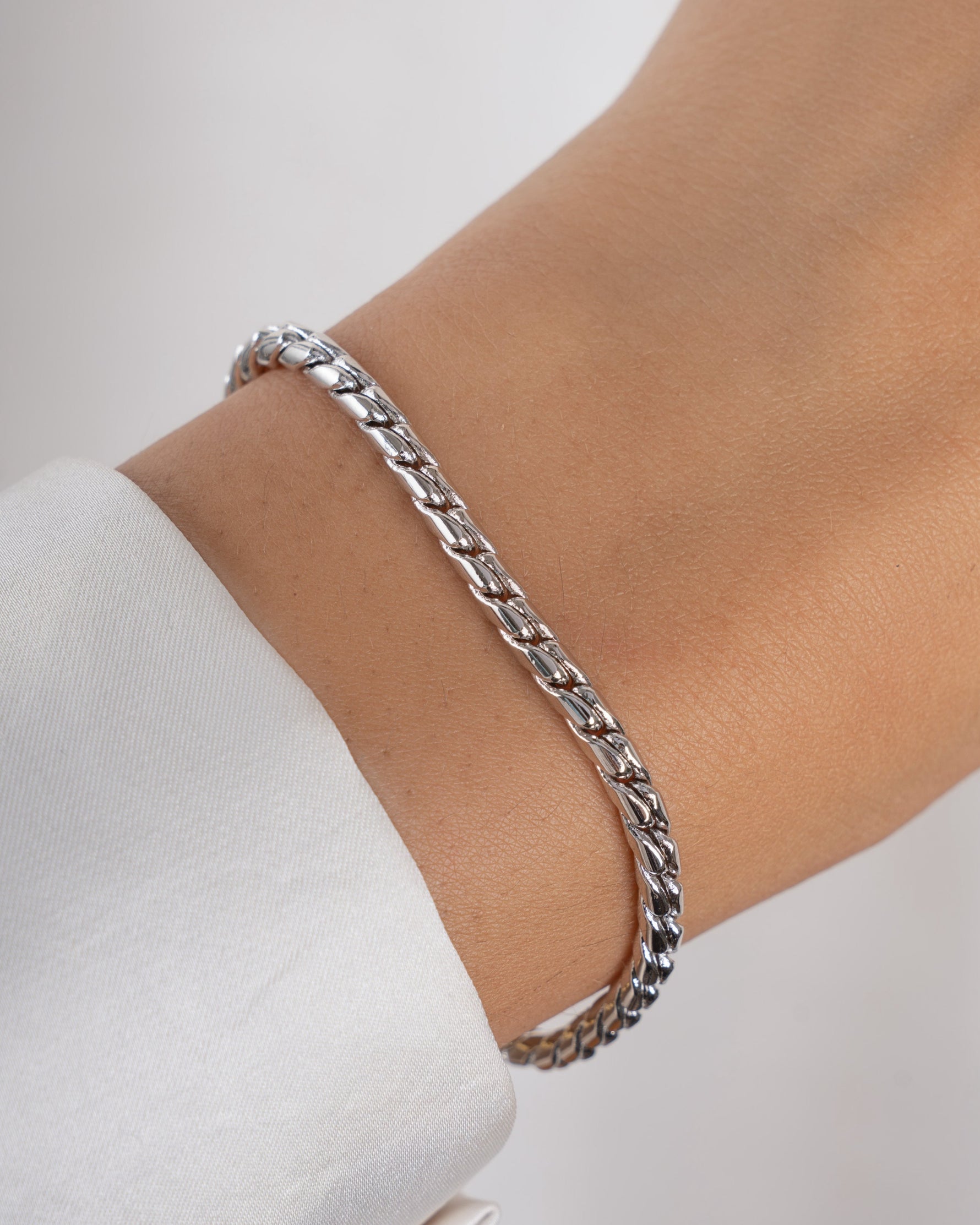 Silver minimalist bracelet on a models wrist