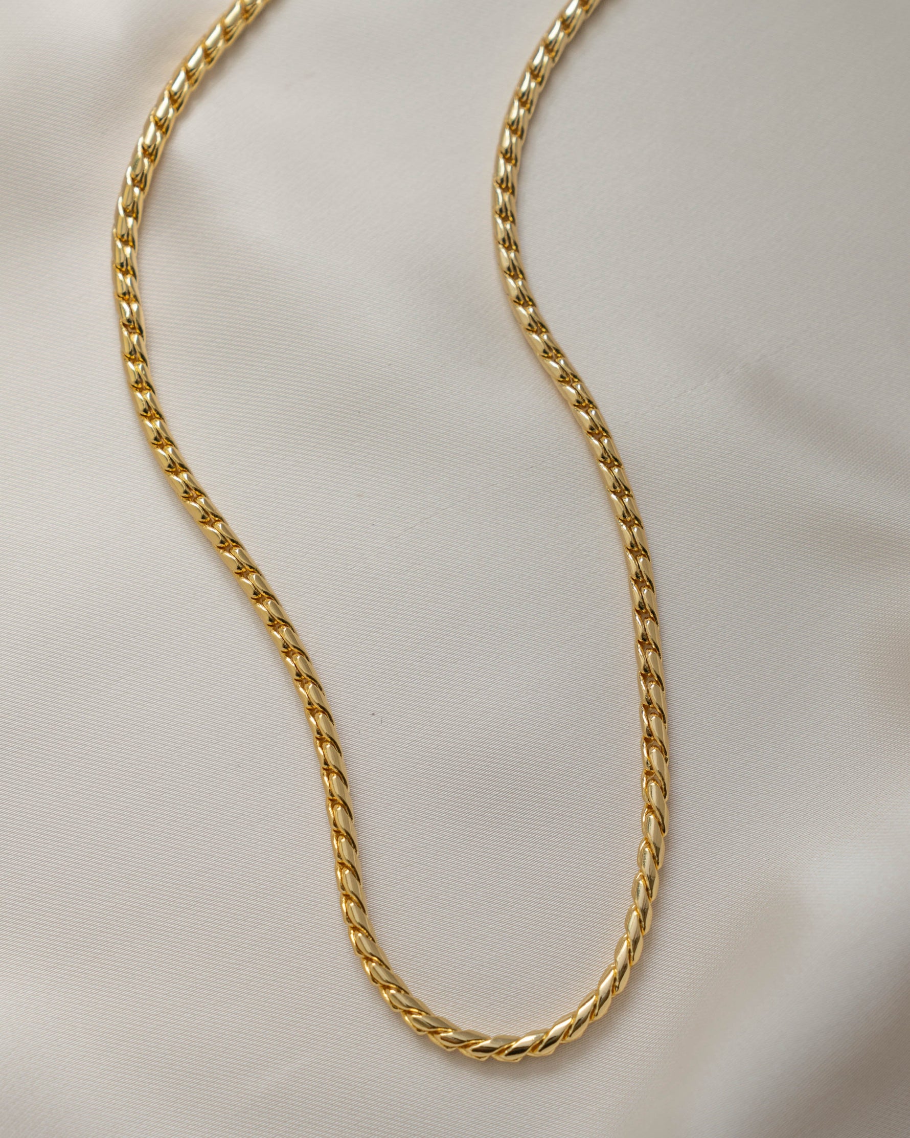 Gold chain vintage necklace on a silky background