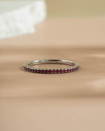 Sterling silver ruby ring on a beige surface