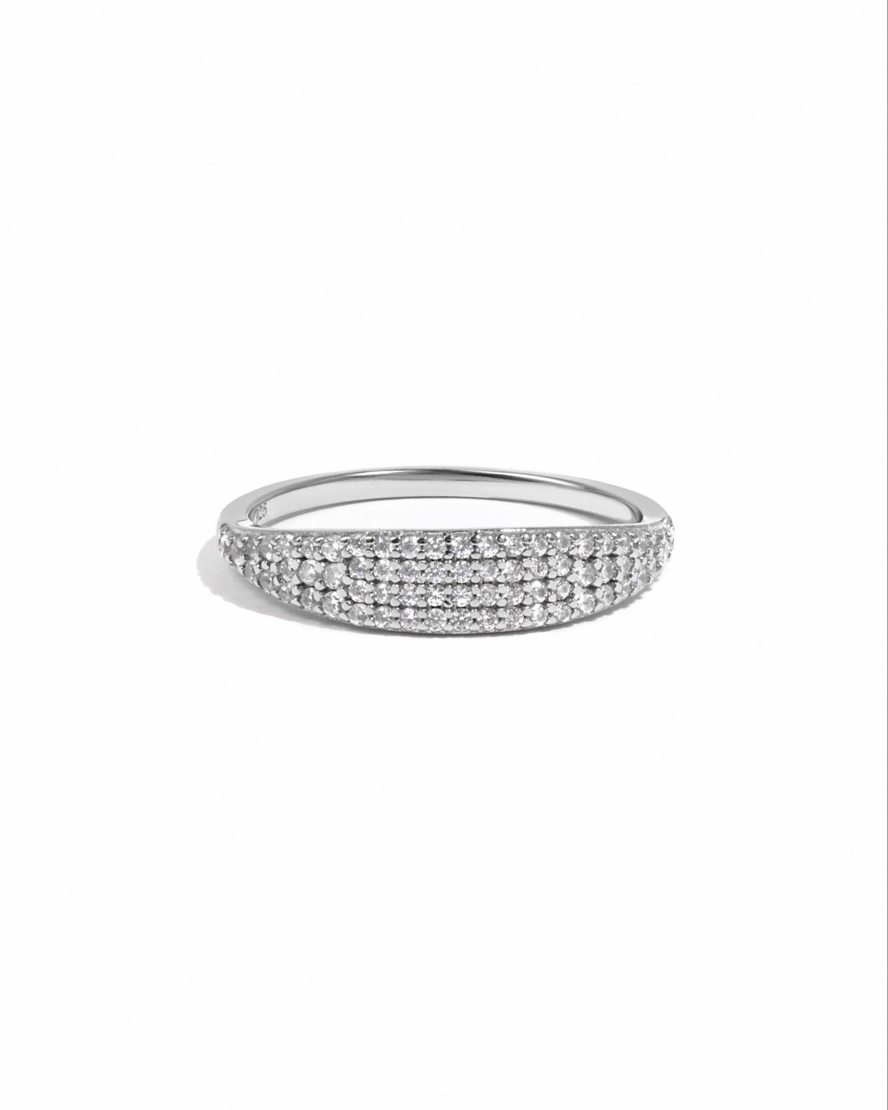 Silver signet ring with small pave cubic zirconia stones on a white background