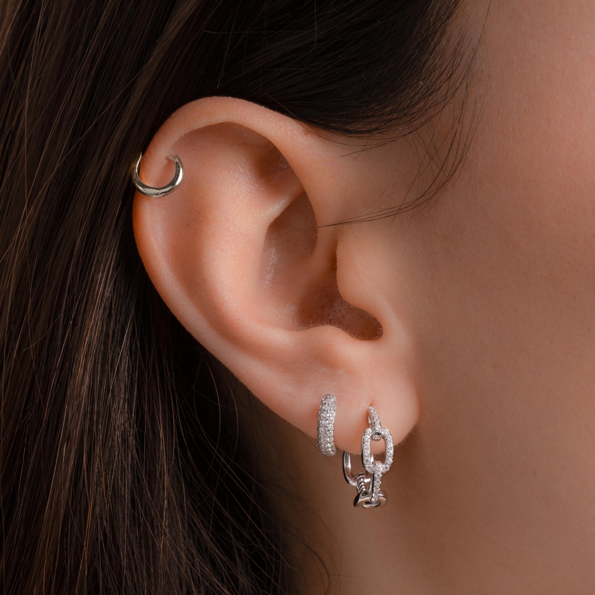 model wearing minimalist silver earrings featuring a delicate cubic zirconia silver hoop earring 